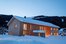 Holzhaus mit Ferienwohnungen beleuchtet im Schnee am Erlenhof in Bad Hindelang